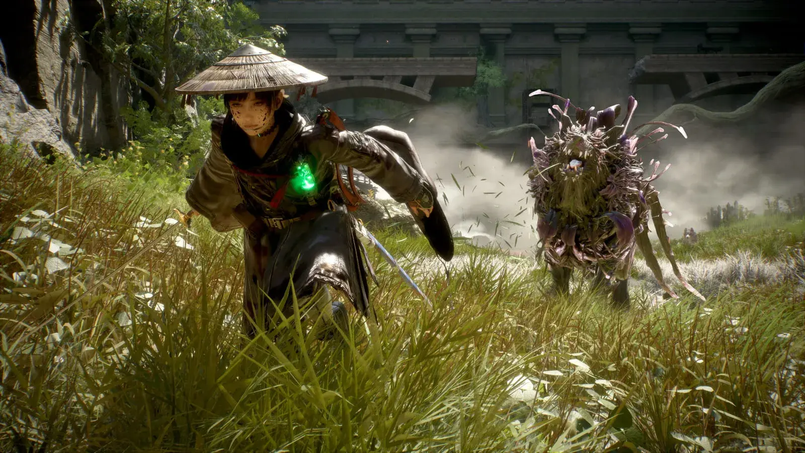 Emma lunging through tall grass with her sword drawn and a green glowing charm at her chest, facing a shaggy plant-covered creature bristling with purple petals